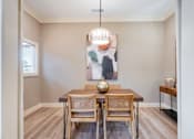 Thumbnail 17 of 54 - A dining room with a wooden table and chairs.