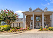 Thumbnail 16 of 19 - A large clubhouse with a front yard and a driveway at Heights at New Garden apartments in Greensboro, NC.