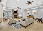 Thumbnail 8 of 14 - A living room with a fireplace and a ceiling fan.