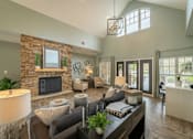 Thumbnail 5 of 21 - a living room with a stone fireplace and a couch