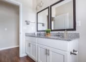 Thumbnail 32 of 32 - a bathroom with a vanity with two mirrors and a sink