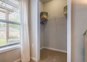 Thumbnail 26 of 32 - a walk in closet with a large window and a white curtain