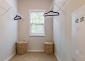 Thumbnail 22 of 32 - a walk in closet with two baskets and a window