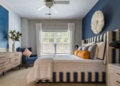 Thumbnail 21 of 32 - a blue and white bedroom with a bed and a ceiling fan