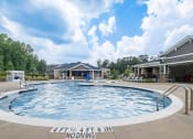 Thumbnail 1 of 32 - a large pool with a house in the background