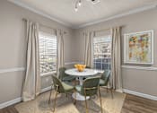 Thumbnail 6 of 19 - A dining room with a table and chairs at Heights at New Garden apartments in Greensboro, NC.
