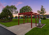 Thumbnail 5 of 24 - a park with a pavilion and a trash can