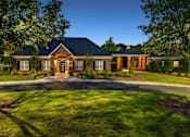 Thumbnail 2 of 24 - a painting of a house with a field of grass and trees