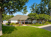Thumbnail 25 of 29 - a home in a neighborhood with trees and a sidewalk