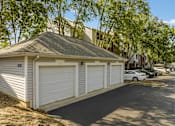 Thumbnail 10 of 29 - a small garage with white doors on the side of a street