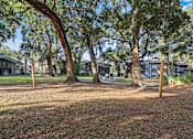 Thumbnail 9 of 33 - firepit and lounge area with hammocks under beautiful south carolina trees