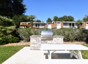 Thumbnail 14 of 20 - a picnic table and a grill in a yard in front of a house