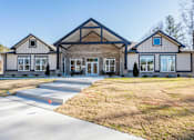 Thumbnail 51 of 52 - A large house with a grey roof and a white garage door.