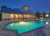 Thumbnail 1 of 20 - Asheville, NC, Pet-Friendly Apartments - Reserve at Asheville - Swimming Pool with Blue Loungers, Pergola, and a View of the Clubhouse.