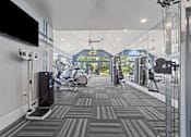 Thumbnail 14 of 19 - A gym with a treadmill, weights, and exercise equipment at Heights at New Garden apartments in Greensboro, NC.