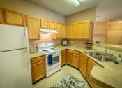 Thumbnail 17 of 21 - a kitchen with a stove refrigerator and a sink