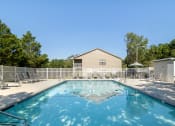 Thumbnail 24 of 35 - our resort style swimming pool is next to our house with chairs and a fence