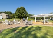 Thumbnail 18 of 35 - a patio with tables and chairs and a white canopy