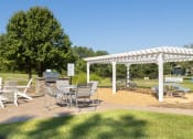 Thumbnail 31 of 35 - a picnic area with a table and chairs under a white canopy