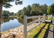 Thumbnail 34 of 35 - a view of a lake with a white fence
