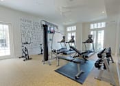 Thumbnail 12 of 19 - Spacious fitness center with a variety of equipment including treadmills, stationary bikes, and weight machines.