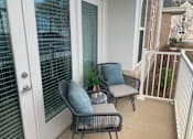 Thumbnail 9 of 19 - A patio with two chairs and pillows on the chairs.