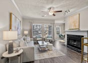 Thumbnail 4 of 19 - A living room with a fireplace and a couch at Heights at New Garden apartments in Greensboro, NC.