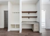 Thumbnail 39 of 54 - A white room with a desk and drawers.