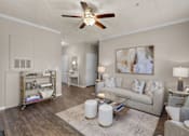 Thumbnail 3 of 19 - A living room with a white ceiling fan and a painting on the wall at Heights at New Garden apartments in Greensboro, NC.
