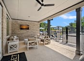 Thumbnail 19 of 54 - A patio with a black rug that says "LET" on it.