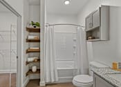 Thumbnail 27 of 54 - A white bathroom with a toilet, sink, and shower.