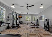 Thumbnail 17 of 52 - A spacious home gym with a variety of exercise equipment.