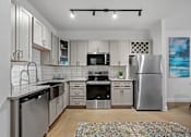 Thumbnail 20 of 52 - A modern kitchen with stainless steel appliances and wooden floors.