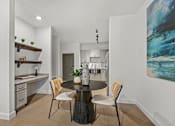 Thumbnail 22 of 52 - A modern kitchen with a dining table set for two.