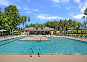 Thumbnail 2 of 52 - A large swimming pool with a building in the background.