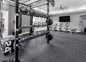Thumbnail 6 of 27 - Fitness center with a weight rack and weights on it.