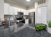 Thumbnail 16 of 27 - View from the kitchen counter of the stainless steel appliances.