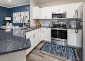 Thumbnail 15 of 27 - Interior kitchen view of stainless steel appliances.