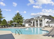 Thumbnail 1 of 19 - A large swimming pool in front of a house at Heights at New Garden apartments in Greensboro, NC.
