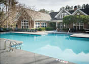 Thumbnail 1 of 21 - a large swimming pool in front of a house