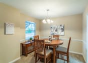 Thumbnail 18 of 20 - a dining room with a table and chairs