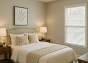 Thumbnail 9 of 15 - A bedroom with a large bed and two lamps.