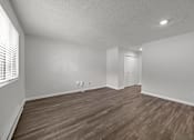 Thumbnail 33 of 52 - A white painted room with wooden flooring and the side of a window.