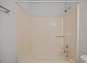 Thumbnail 20 of 52 - A white bathroom with a peach color bathtub.