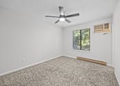 Thumbnail 36 of 52 - Open room with a ceiling fan and a window with blinds.