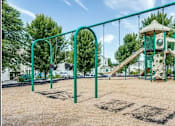 Thumbnail 3 of 20 - A playground with a green slide and a tower.