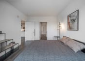 Thumbnail 20 of 34 - a bedroom with a large bed and a painting on the wall