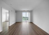 Thumbnail 31 of 34 - an empty living room with white walls and wood floors