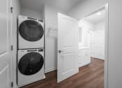 Thumbnail 24 of 34 - white laundry room with washer and dryer in a small apartment