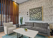 Thumbnail 3 of 17 - A living room with a grey couch, a white coffee table, and a painting on the wall.